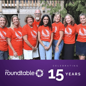 Roundtable Team in orange 'every child matters' tshirts celebrating 15 years