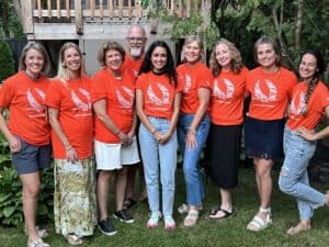 Roundtable Team standing in a backyard wearing orange 'every child matters' tshirts
